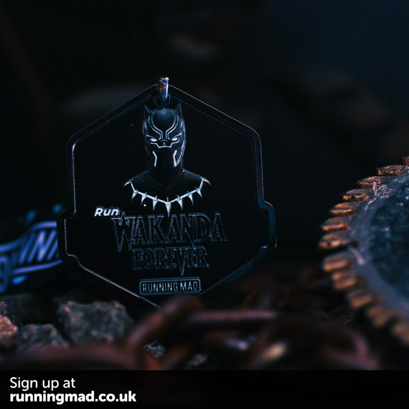 Black Panther themed running medal with vibrant tribal design background.