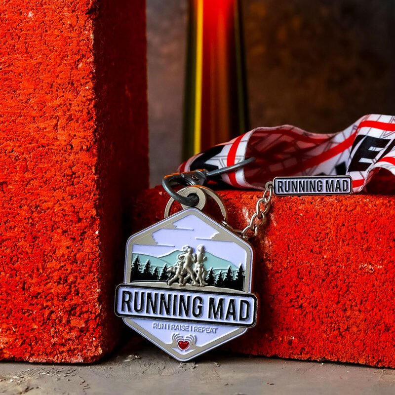Running Mad medal with ribbon on orange textured background.