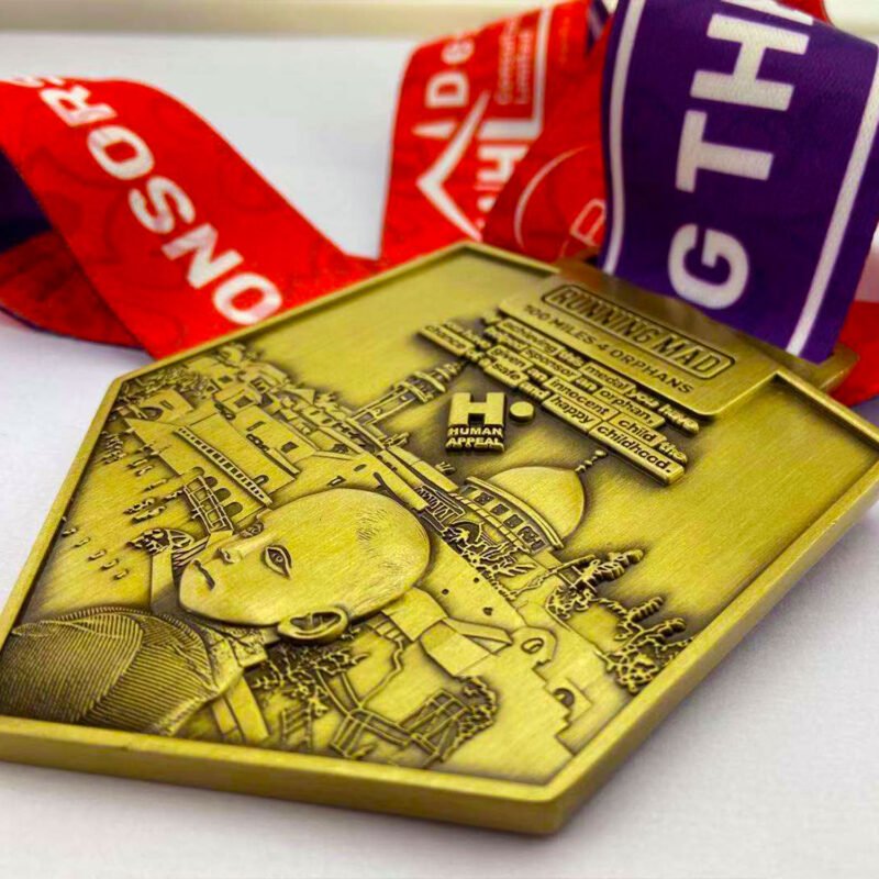 Golden charity medal for running event supporting orphan welfare