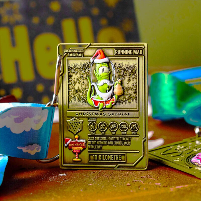 Alien character in Santa outfit on a festive running medal