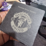 Custom-engraved slate coaster with Manchester United logo and personalized name